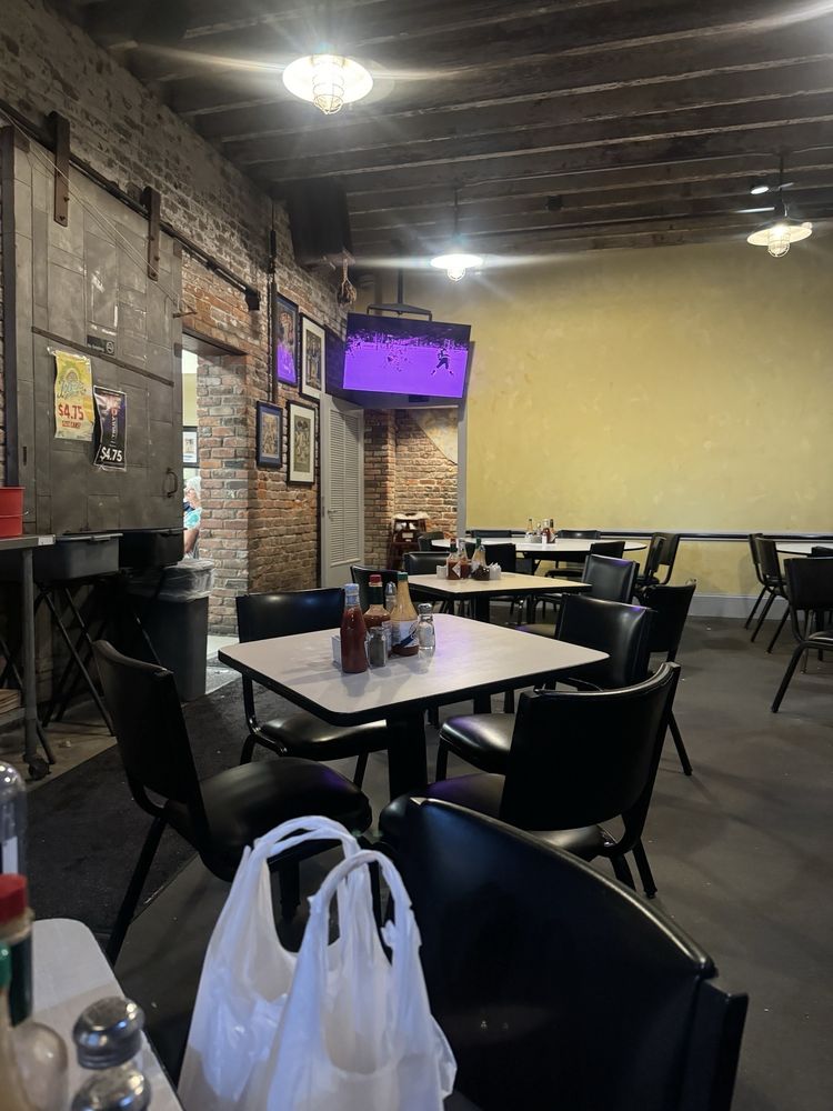 tv and tables in mother's restaurant interior